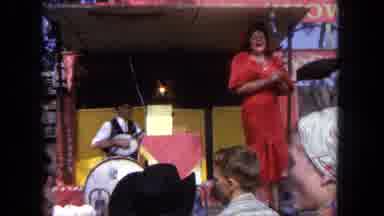 Tijuana Mexico (1962): A Lady In A Red Dress Claps Then Hands Things Out To Crowd