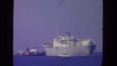 San Diego California-1962: Large Cargo Ship Towed By Tugboat In Ocean