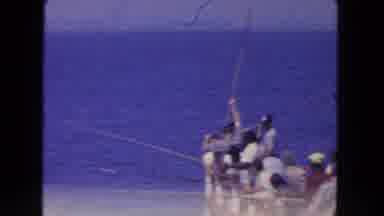 San Diego California (1962): A Group Of Men Fishing On A Boat And One Pulls The