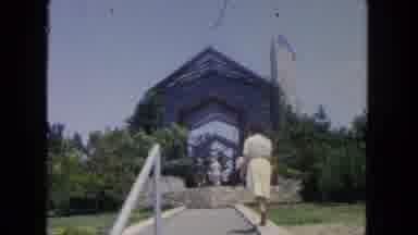 San Diego California (1962): A Lady In A Dress Walks Up Stairs And Down A Path To