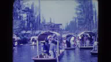 Mexico City (1962): A Large Group Of People Rowing Their Boats Along The Water