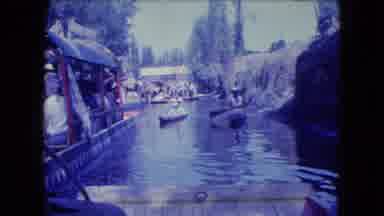Mexico City (1962): Two People Paddling In A Little Boat With Another Big Boat
