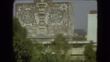 Mexico City (1962): Large Building It Intricate Designs Next To A Painted Mural
