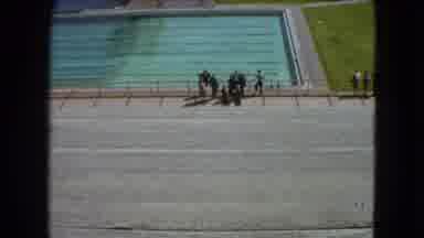 Mexico City (1962): People Stand Outside A Large Outdoor Pool That No One Is Using