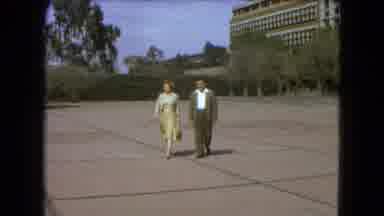Mexico City (1962): Man And Woman Walk Across The Lot To Go See The Soccer Match