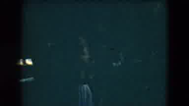Mexico City (1962): Person Wearing Red Shirt Walks Quickly Through Dimly Lit Room