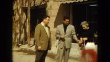 Mexico City (1962): Two Men In Suits Walk Towards The Camera And Talk