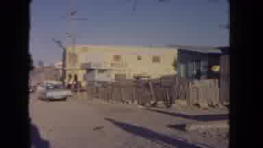 Los Angeles California USA (1962): A Scene Of A Car Building And Speed Limit Sign