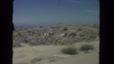 Los Angeles California USA (1962): Driving Down A Dirt Road In The Desert Past A