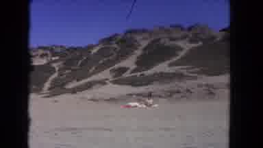 Los Angeles California USA (1962): A Women Sitting On A Sand Hill