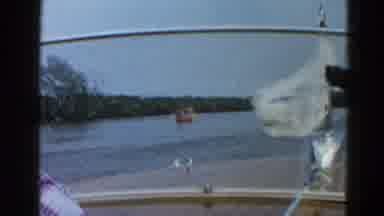 Illinois USA (1962): People In Speedboat Wave As They Pass By Others In A Row Boat