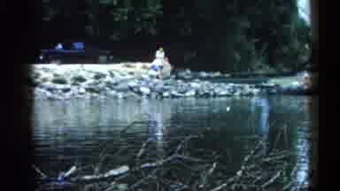 Illinois USA (1962): People Are Sitting On The Stones Of The Shore Of River