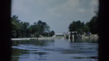 Illinois USA (1962): Boat Ride Through A Wide River In The Daylight With Rocks On
