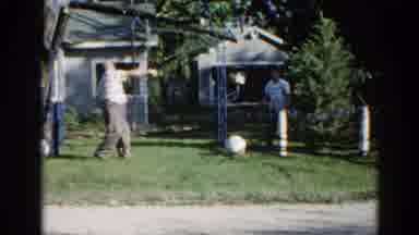 Illinois USA (1962): Man Trying To Pull A Limb From A Tree In The Front Yard