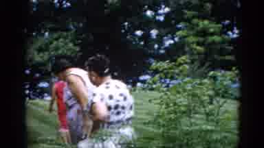 Illinois USA-1962: Camera Pans Across Lawn Capturing Mothers and Children