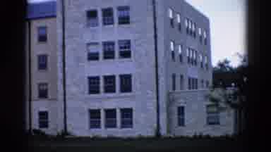 Illinois USA (1962): Slow View Of Four Story Long Tan Building On A Campus