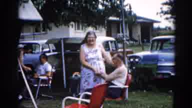 Illinois USA (1962): Grandma And Grandpa At A Picnic On A Windy Day Standing