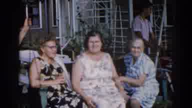 Illinois USA (1962): Three Women Swinging On A Swing While Another Woman Talks To