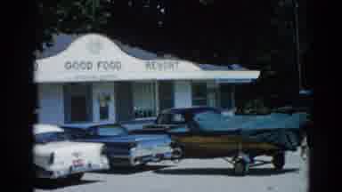Illinois USA (1962): View Of Blue Boat Parked In Front Of White Cafe Building On A
