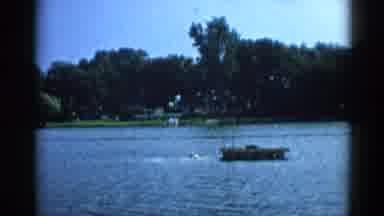 Illinois USA (1962): Two Swimmers Swimming To A Square Wooden Dock Anchored In The