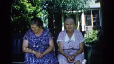 Illinois USA (1962): Two Older Woman Sitting On A Porch Swing On A Sunny Afternoon