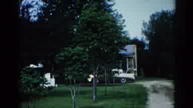 Illinois USA (1962): Middle Age Woman Stands In Front Of Pond That Is Near Her