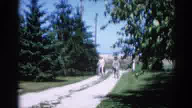 Illinois USA (1962): Two Girls Rolling Down The Street In The 90s