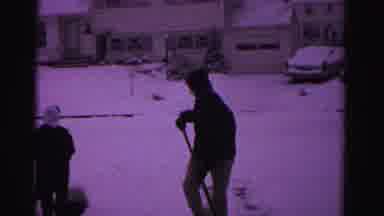 Hagerstown Maryland USA-1962: Two People Dressed In Winter Clothes Shovel Their Driveway