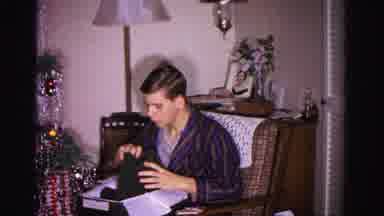 Hagerstown Maryland USA (1962): Boy Opening And Inspecting Present In Front Of A