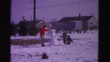 Hagerstown Maryland USA (1962): Three People Put Finishing Touches On Snowman In A