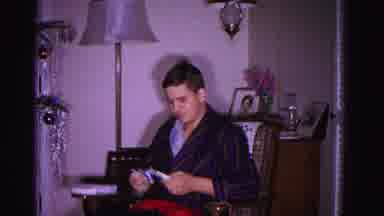 Hagerstown Maryland USA (1962): Old Home Video Of A Man Sitting In A Chair Opening