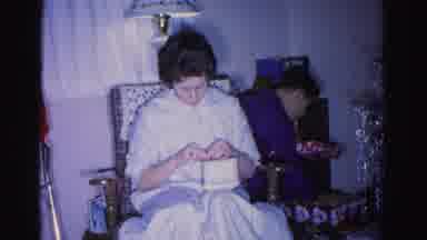 Hagerstown Maryland USA (1962): A Woman Opens A Gift While Someone Looks Through