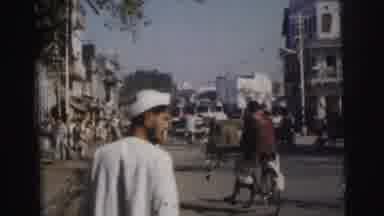 Calcutta India (1962): Two Men White Clothing Walking Down Street Sunny Day Bikes