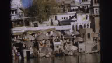 Calcutta India (1962): A Cramped River Bank With People Under Umbrellas And