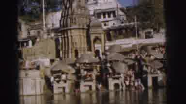Calcutta India (1962): Next To A River Bank People Wash Clothing Some Sit Under