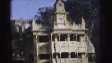 Calcutta India (1962): View Of Clock Tower With People Wading In River Water On A