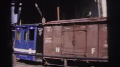 Calcutta India (1962): Small Train Goes By On The Tracks As People Walk Around On