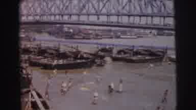 Calcutta India (1962): People Under A Bridge In The River Cleaning Or Hunting Food