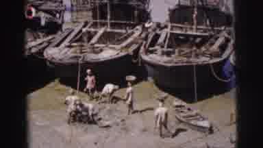 Calcutta India (1962): The People Fill Baskets At The Water Next To Boats