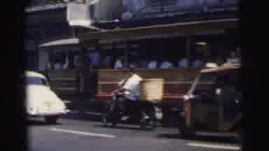 Calcutta India-1962: Montage Of City Scenes Featuring Trams, Cars, Motorbikes And A Rhino