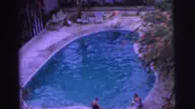 Calcutta India (1962): Woman In Black Bathing Suit And Swimming Cap Chats With Man