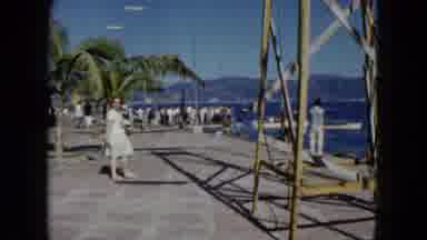 Acapulco Mexico-1962: Woman Walks On The Dock As Ship Filled With People Watch