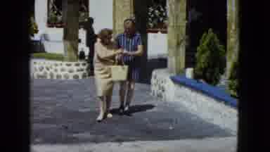 Acapulco Mexico (1962): One Women And One Men Walking And Touching Money In The