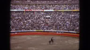 Acapulco Mexico (1962): Men Enter A Busy Stadium In Lineone On Horse And Then