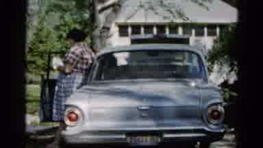Wauconda Illinois USA (1961): A Woman Leans On A Vehicle There Is Someone Sitting