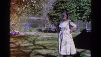 Wauconda Illinois USA (1961): Grandmother Standing Underneath A Tree In Front Of
