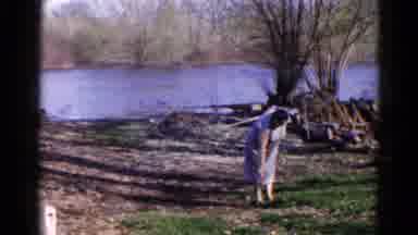 Wauconda Illinois USA-1961: Woman Walking By River Checking Her Foot