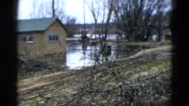 Wauconda Illinois USA (1961): View Of Calm Lake And Brown Building On A Clear Day