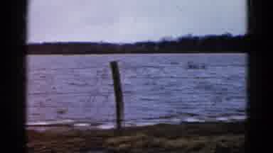 Wauconda Illinois USA (1961): Camera Pans Along Flowing Water Fence In The