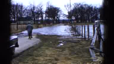 Wauconda Illinois USA (1961): Man And Woman Walk On Cement Walkway Toward Flowing